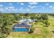 Scenic aerial view of the property with a pool, pond, and surrounding greenery, offering a tranquil retreat at 919 Palm View Way, Sarasota, FL 34240