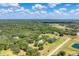 Vast aerial landscape with homes nestled among lush trees and ponds, providing a peaceful environment at 919 Palm View Way, Sarasota, FL 34240