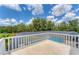 View from spacious balcony with screened-in pool and mature trees at 919 Palm View Way, Sarasota, FL 34240