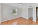 Bright bedroom featuring wood floors and a sunny window with a view at 919 Palm View Way, Sarasota, FL 34240
