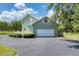 Exterior showcasing two-story home with an attached garage, a circular driveway, and green awning at 919 Palm View Way, Sarasota, FL 34240