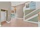 Elegant foyer with chandelier, high ceilings, and a grand staircase creates a welcoming entrance at 919 Palm View Way, Sarasota, FL 34240