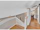 Bright upstairs hallway with hardwood floors and stained glass at 919 Palm View Way, Sarasota, FL 34240