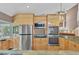 Gourmet kitchen with stainless steel appliances, custom cabinetry, and granite countertops at 919 Palm View Way, Sarasota, FL 34240