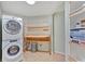 Functional laundry room with stacked washer/dryer and a convenient folding table for added efficiency at 919 Palm View Way, Sarasota, FL 34240