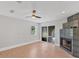 Living room with hardwood floors, ceiling fan and a modern stone fireplace at 919 Palm View Way, Sarasota, FL 34240
