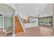 Unique living area with custom bar, staircase, and large windows offering plenty of natural light at 919 Palm View Way, Sarasota, FL 34240