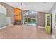 Bright living area features fireplace, floor-to-ceiling windows with pool view, and stylish decor at 919 Palm View Way, Sarasota, FL 34240