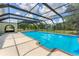 Inviting screened-in pool area with an adjacent spa and covered outdoor seating for ultimate leisure at 919 Palm View Way, Sarasota, FL 34240