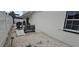 Backyard exterior view showcases gravel landscaping, privacy fence, and outdoor seating at 1016 Rhodes Ave, Sarasota, FL 34237