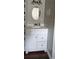 Bathroom featuring a white vanity with drawers and cabinets, a quartz countertop, and an oval mirror at 1016 Rhodes Ave, Sarasota, FL 34237