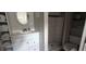 Bathroom featuring a white vanity with storage next to a shower with updated tiling and fixtures at 1016 Rhodes Ave, Sarasota, FL 34237