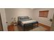 Bedroom showcasing a metal bed frame with wood floors and a decorative rug at 1016 Rhodes Ave, Sarasota, FL 34237