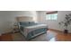 Bedroom featuring a comfortable bed with blue quilt and a large area rug, creating a relaxing atmosphere at 1016 Rhodes Ave, Sarasota, FL 34237
