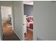 View from hallway of bedrooms with stylish beds; one room features a black accent wall and another has a plush area rug at 1016 Rhodes Ave, Sarasota, FL 34237