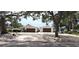Charming single-story home featuring an expansive driveway and a 2-car garage with mature trees at 1016 Rhodes Ave, Sarasota, FL 34237