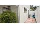 Side exterior of home featuring a brick pathway and tidy landscaping providing curb appeal at 1016 Rhodes Ave, Sarasota, FL 34237