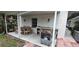 Patio exterior view features a grill, table, chairs, and a propane tank at 1016 Rhodes Ave, Sarasota, FL 34237
