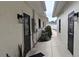 Side yard featuring black doors, lush landscaping, and outdoor lighting at 1016 Rhodes Ave, Sarasota, FL 34237