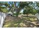 Grassy backyard boasts mature trees and a convenient grill area for outdoor enjoyment at 1019 S Tuttle Ave, Sarasota, FL 34237
