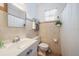 Cozy bathroom features a neutral tile, window, and ample countertop space at 1019 S Tuttle Ave, Sarasota, FL 34237