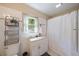 Well-lit bathroom featuring a vanity, mirror, and shower with curtain at 1019 S Tuttle Ave, Sarasota, FL 34237