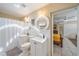 Bright bathroom featuring dual vanities, mirrors, and a tub shower at 1019 S Tuttle Ave, Sarasota, FL 34237