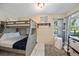 Comfortable bedroom with a bunk bed, soft carpet, and natural light from the windows at 1019 S Tuttle Ave, Sarasota, FL 34237