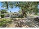 Charming exterior with tidy landscaping, a stone accent wall, and generous parking at 1019 S Tuttle Ave, Sarasota, FL 34237