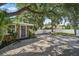 Inviting home exterior showcasing stone accents, lush landscaping, and white fence at 1019 S Tuttle Ave, Sarasota, FL 34237
