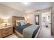 The main bedroom boasts tiled floors, comfortable bedding, and an en-suite bathroom at 1019 S Tuttle Ave, Sarasota, FL 34237