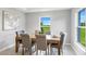 Cozy dining room with stylish decor, neutral color palette and serene view of outdoors at 10539 Kidron Ave, Englewood, FL 34224
