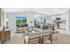 Inviting open-concept living room features neutral paint, modern decor and flows into kitchen and dining areas at 10539 Kidron Ave, Englewood, FL 34224