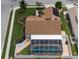 Aerial view of home showcasing landscaped yard, pool with screened enclosure, solar panels and proximity to green spaces at 11021 4Th E Ave, Bradenton, FL 34212