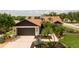 Beautiful aerial view of home showcasing lush landscaping, great neighborhood, and solar panels at 11021 4Th E Ave, Bradenton, FL 34212