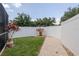 Relaxing back yard with white fence, lush green grass, and decorative plants at 11021 4Th E Ave, Bradenton, FL 34212
