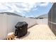 A backyard with a brick patio, grill, and white privacy fence at 11021 4Th E Ave, Bradenton, FL 34212
