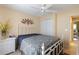 Comfortable bedroom featuring ceiling fan, adjacent closet and view to outdoors at 11021 4Th E Ave, Bradenton, FL 34212