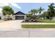 Charming home with lush landscaping, palm trees, a two-car garage, and great curb appeal at 11021 4Th E Ave, Bradenton, FL 34212
