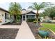 Charming home featuring a well-manicured yard with palm trees and inviting entrance at 11021 4Th E Ave, Bradenton, FL 34212