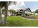Manicured front lawn featuring lush grass, a variety of plants, and dark mulch at 11021 4Th E Ave, Bradenton, FL 34212