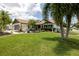 Charming single-Gathering home with a well-manicured lawn, mature palms, and a welcoming front porch at 11021 4Th E Ave, Bradenton, FL 34212
