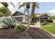 Landscaped front yard featuring palm trees and dark mulch surrounding the flower beds at 11021 4Th E Ave, Bradenton, FL 34212