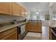 View of the kitchen featuring granite countertops, stainless steel appliances, and wood cabinets at 11021 4Th E Ave, Bradenton, FL 34212