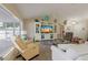 Bright living room with large TV, beige furniture, and an abundance of natural light at 11021 4Th E Ave, Bradenton, FL 34212