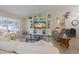 Bright living room with large windows, vaulted ceiling, and entertainment center at 11021 4Th E Ave, Bradenton, FL 34212