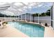 Beautiful swimming pool featuring a sun shelf and relaxing resort-style backyard at 11021 4Th E Ave, Bradenton, FL 34212