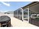 Outdoor living space with screened-in pool, brick paved patio, and a covered area with seating at 11021 4Th E Ave, Bradenton, FL 34212
