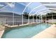 A sparkling pool with a screen enclosure and small water feature at 11021 4Th E Ave, Bradenton, FL 34212