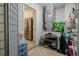 A storage room with an air conditioning unit, shelves, and an open door to a kitchen at 11021 4Th E Ave, Bradenton, FL 34212